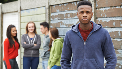 Group of teenagers talking with one looking at the user