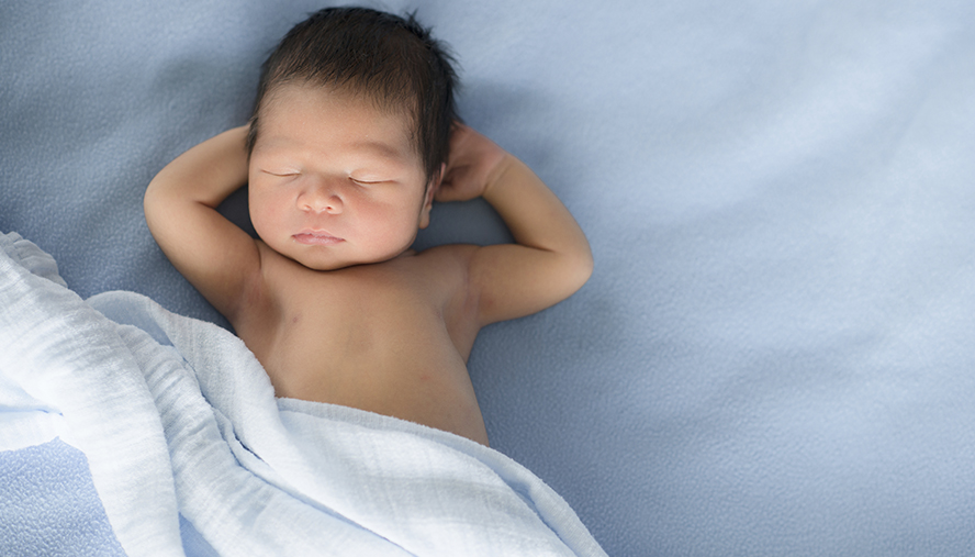 infant asleep on their back