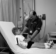 Erwin Gelfand, MD, meets with a patient.