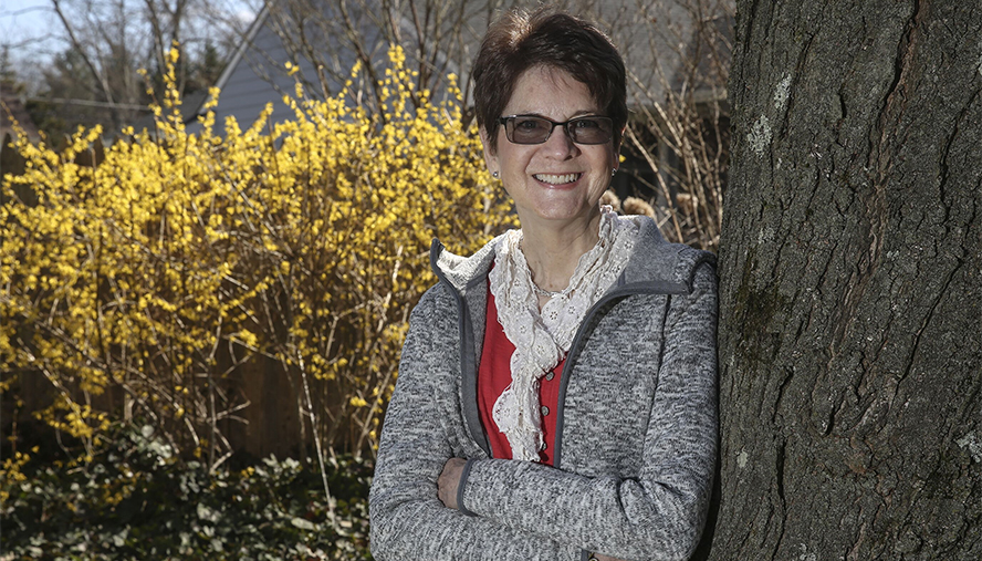 Martha Crothers standing by a tree