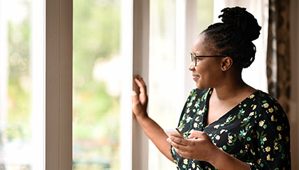 woman looking out her window