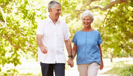 two seniors walking outside