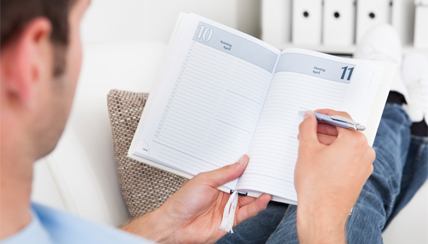 Man reviewing his daily planner