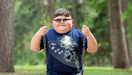 Dane Cuesta on a swing