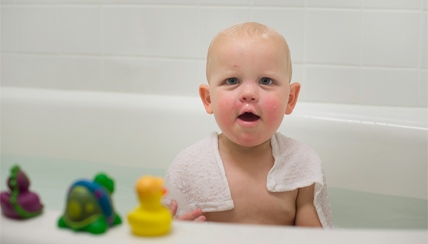 infant in a bath tub