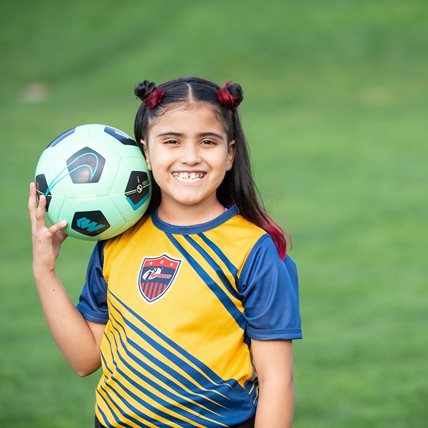 girl holding soccer ball