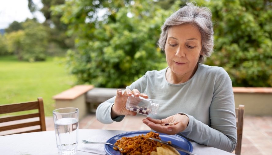 Woman pouring vitamins into her hand