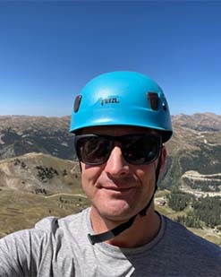 Tim Lahm with a scenic background