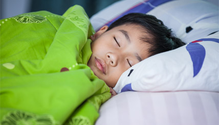 boy sleeping in his bed