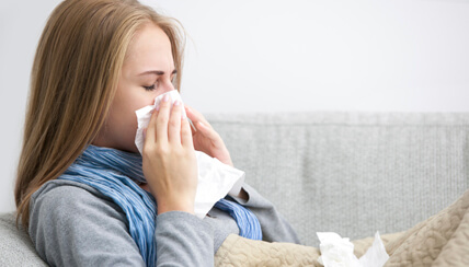 woman blowing her nose