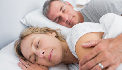 two adults sleeping soundly