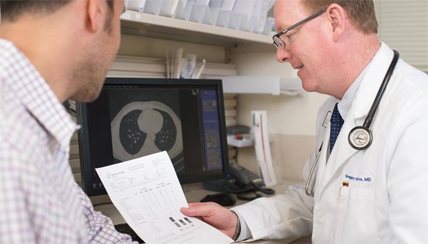two physicians reviewing health records