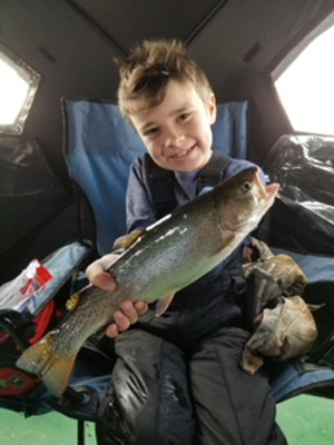 Noah Fitzsimmons holding a fish