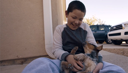 caleb playing with puppy