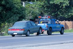 Car being towed by a truck