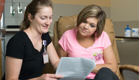 patient and physician reviewing documents