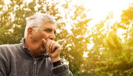 man covering his cough