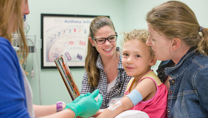 Physician and child getting allergy treatment